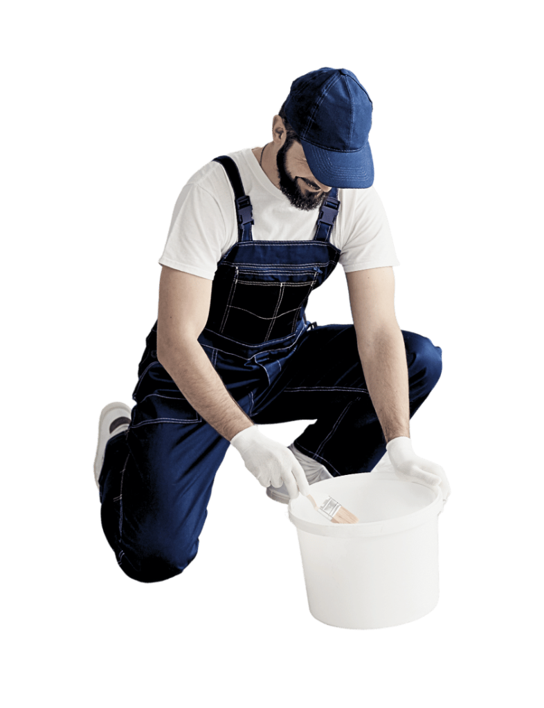 waterproofer wearing denim overalls mixing brush in a white bucket
